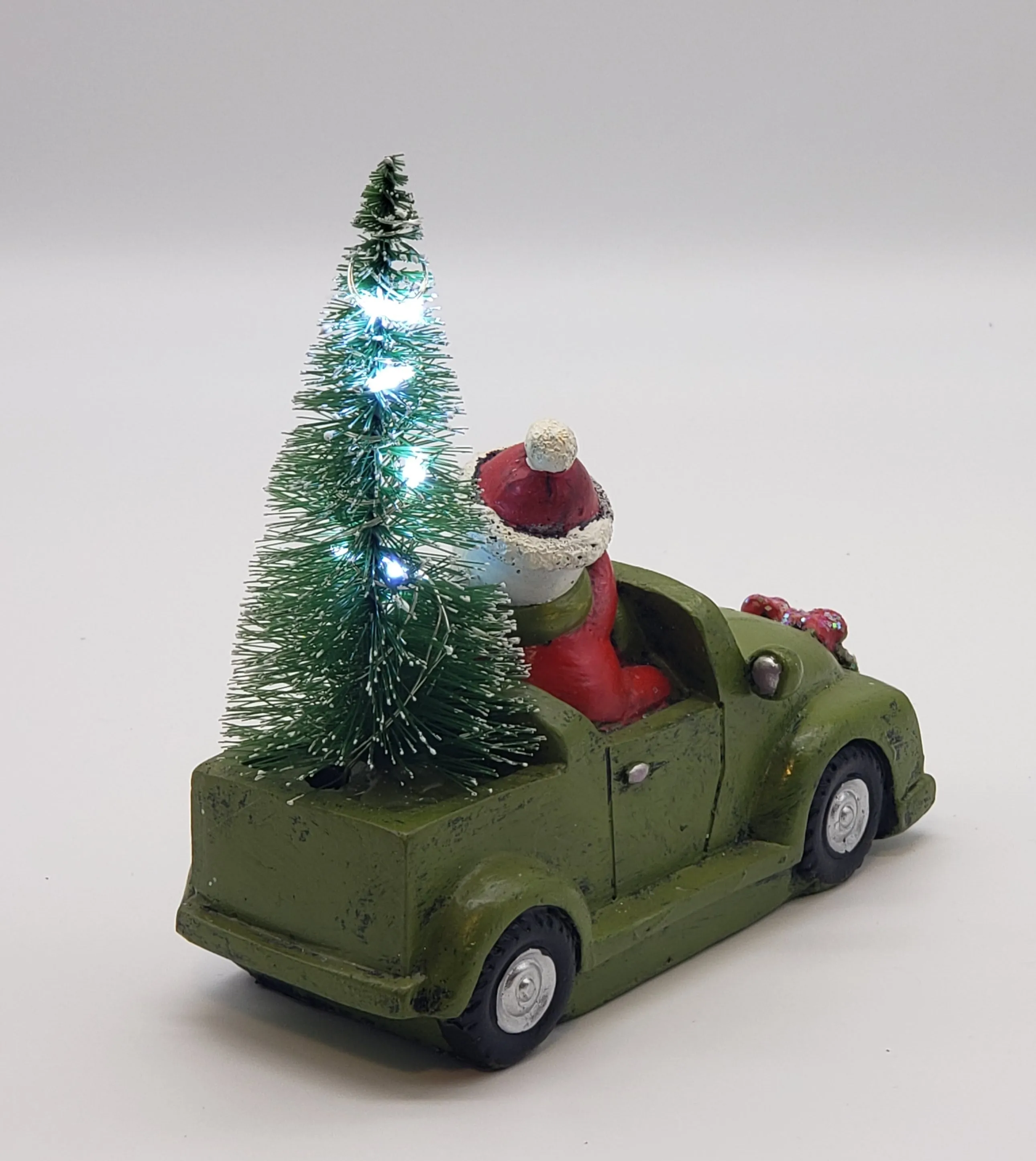 Snowman with his Christmas tree in a Car- Christmas decorations